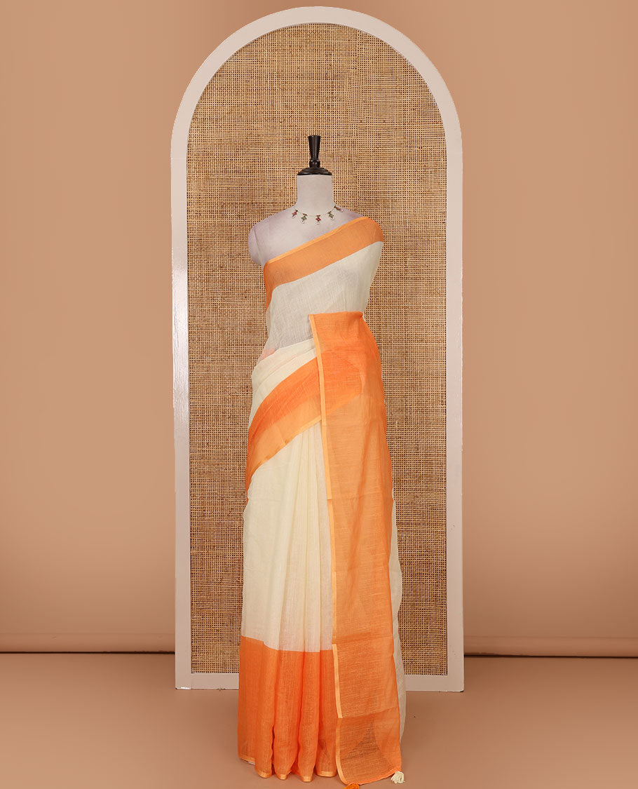 Cream full-plain linen saree, contrast orange big plain border, plain pallu & buttas printed matching blouse