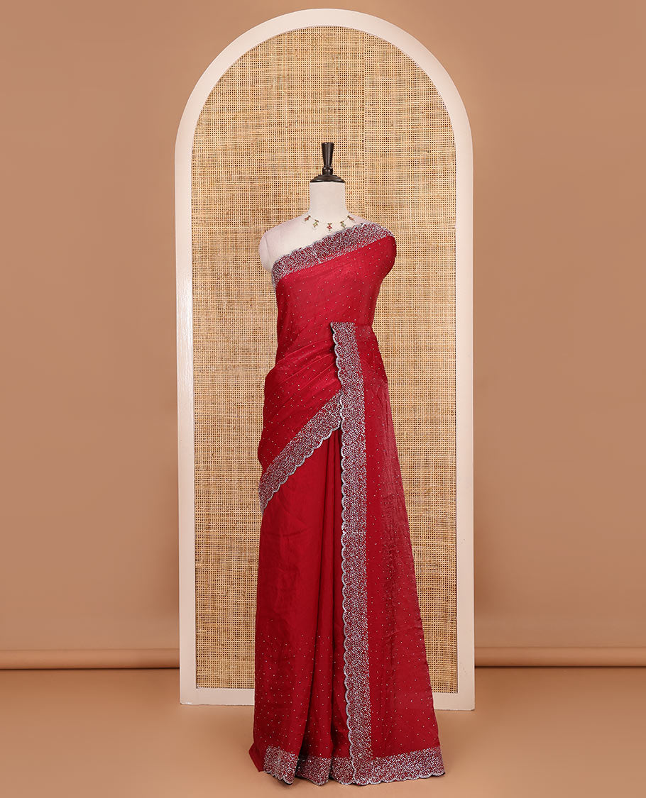Maroon Swarovski crystal stone embedded fendy chiffon saree, scallop Swarovski stone embroidered border, and contrast plain blouse