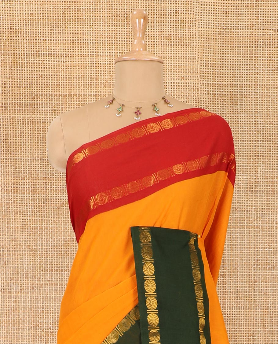 Orange plain sungudi cotton saree with contrast ganga jamuna rettai pettu zari border, zari striped pallu, and contrast veldhari striped blouse