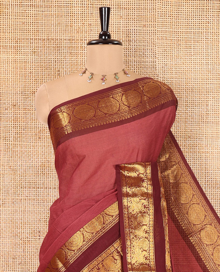 Reddish Brown Plain Chettinad Cotton Saree, Complemented by a Contrast Traditional Zari Border of Peacock-Chakram Designs, Subtly Striped Pallu, and Paired with a Matching Blouse