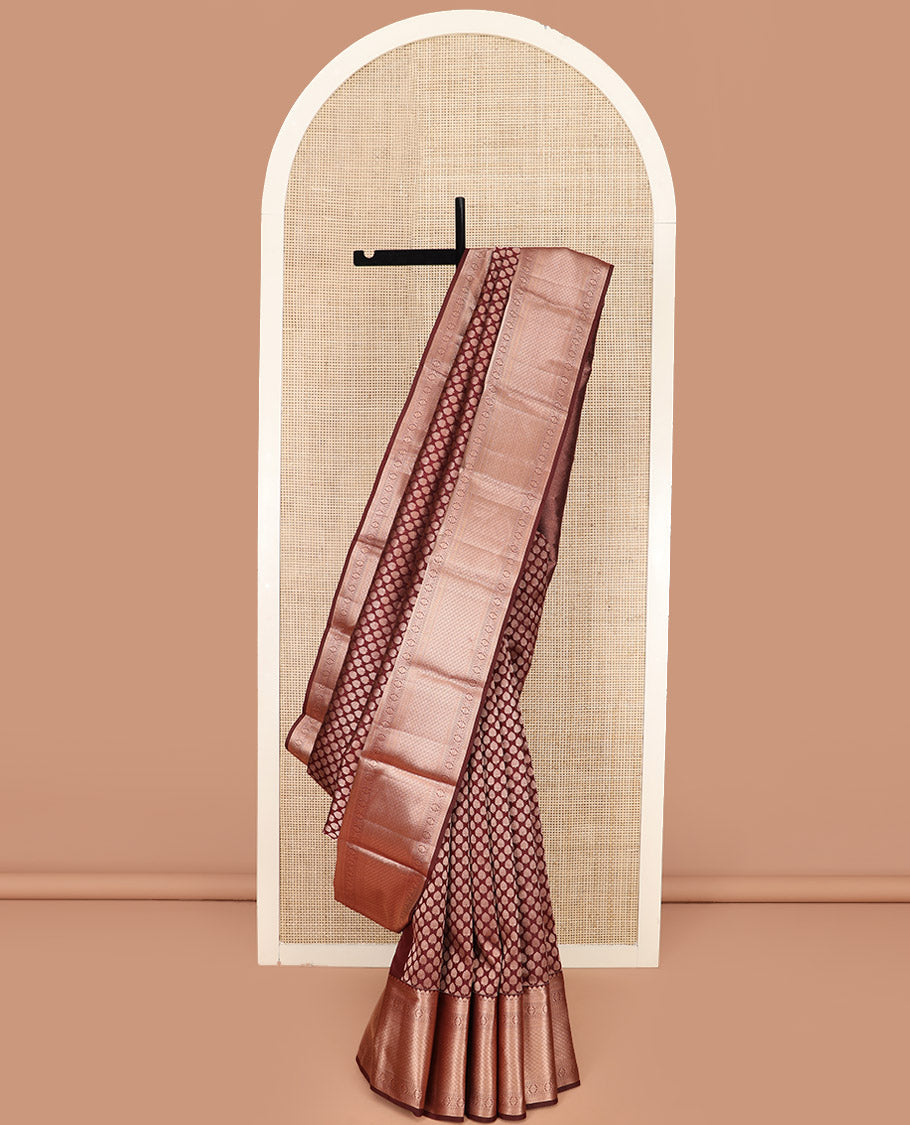 Brown Kanchipuram Silk Saree Enlivened with Zari Buttas, Complemented by Zari Border of Kathir, Neli, Kamalam, Chakram, Manga, and Mayil Kann Designs, Pallu Decked Up with Mayil Kann Designs, and Paired with a Matching Blouse