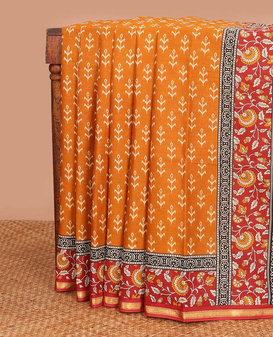 Orange floral motifs printed mul mul cotton saree, contrast floral vine printed border, and pallu of floral print
