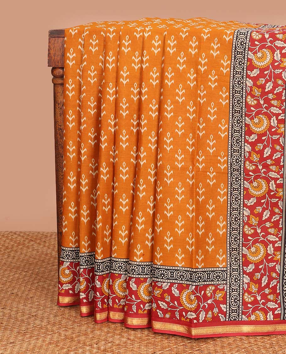 Orange floral motifs printed mul mul cotton saree, contrast floral vine printed border, and pallu of floral print