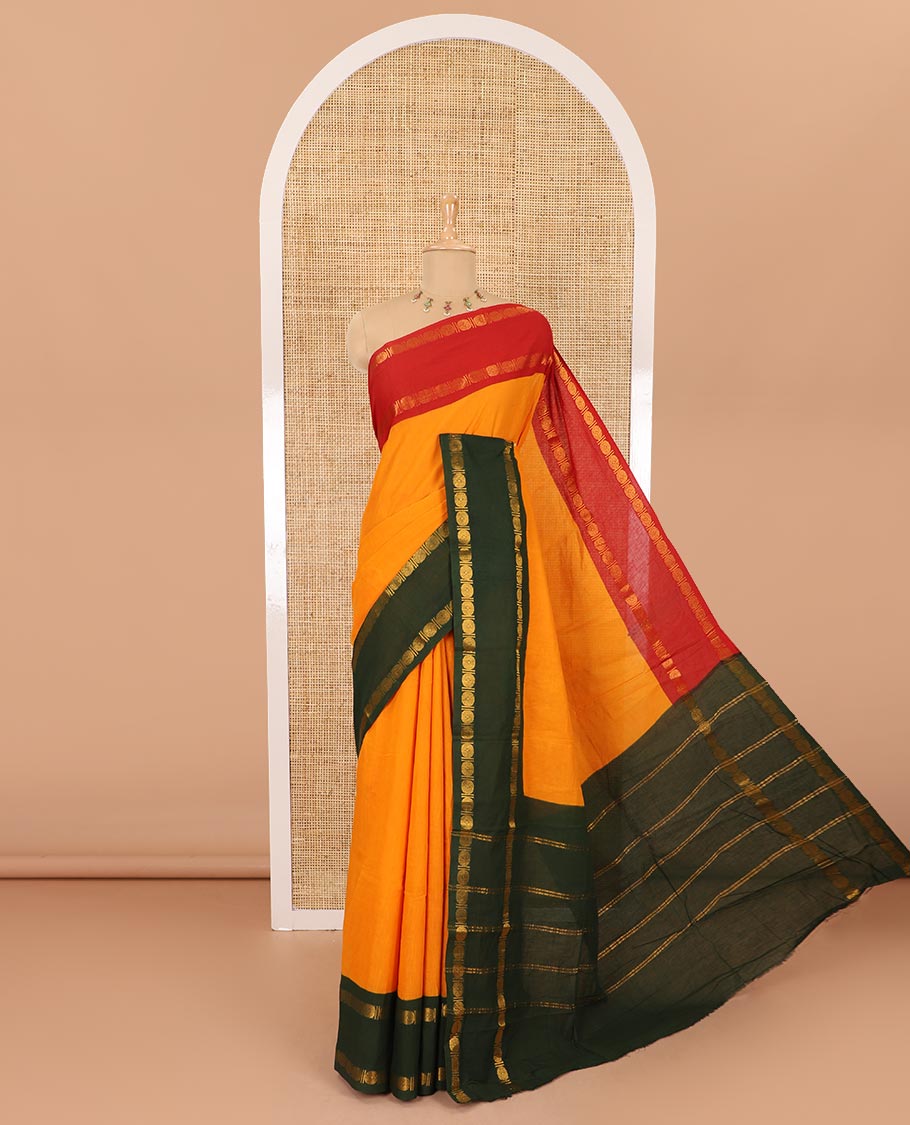 Orange plain sungudi cotton saree with contrast ganga jamuna rettai pettu zari border, zari striped pallu, and contrast veldhari striped blouse