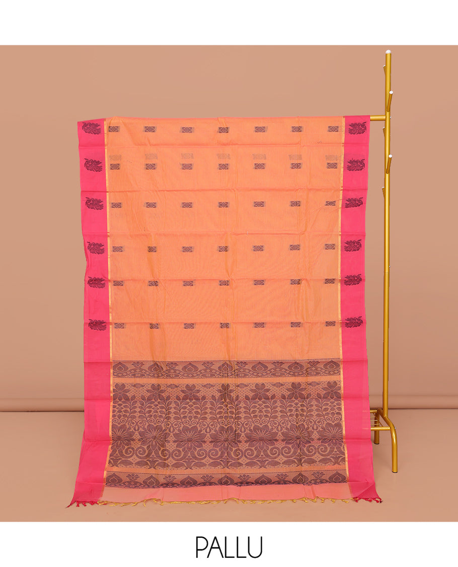 Orange Kanchi Cotton Saree, Decked Up with Buttas All Over Its Body, Complemented by a Contrast Floral Border, Pallu of Floral Designs, and Paired with a Matching Blouse