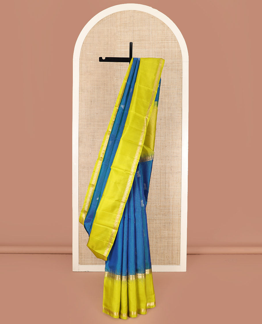 Blue Kanchipuram Silk Saree, Sparsely Sparkled with Muthu Stripes and Jhumka Buttas All Over Its Body, Complemented by a Contrast Rettai Pettu Border of Thilakam Mokku, and Laddu Kamalam Designs, Subtly Sparkled Pallu, and Paired with a Contrast Blouse