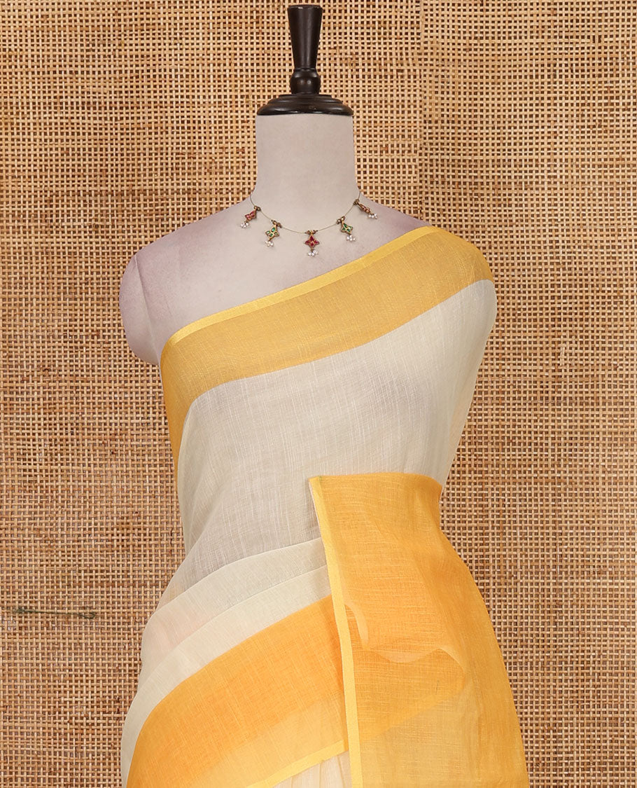 Cream full-plain linen saree, contrast yellow big plain border, plain pallu & buttas printed matching blouse