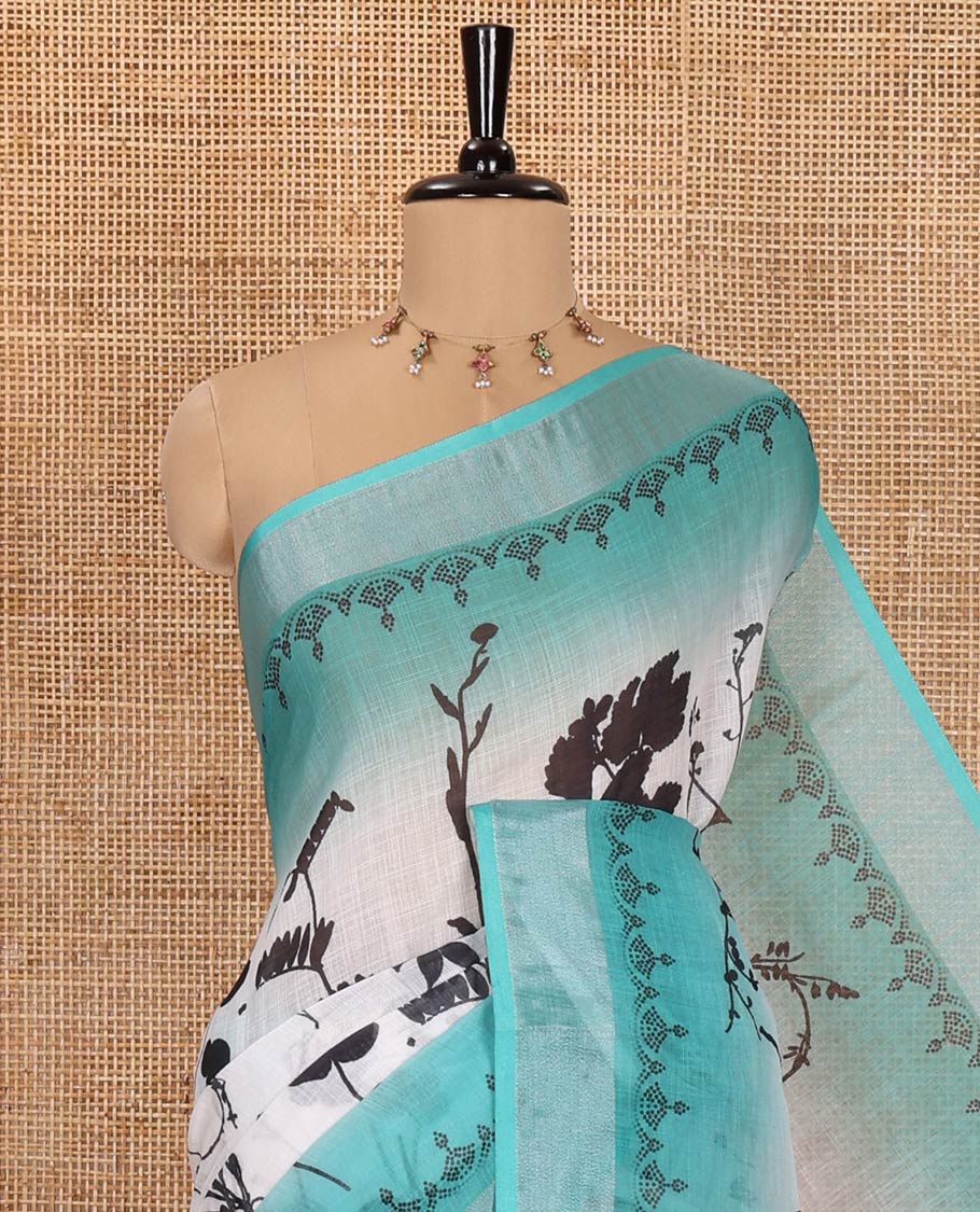 White and Rama Linen Cotton Saree, Bedecked with Silhouette-Style Floral Motifs Printed on Its Body, Complemented by Contrast Bavanji Border, Pallu of Silhouette-Style Floral Print, and Comes with a Matching Blouse