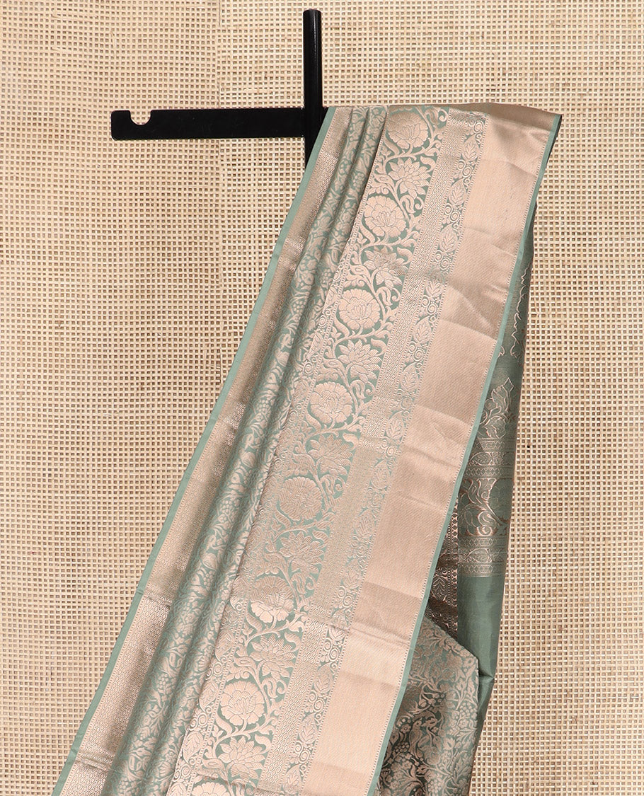 Green Kanchipuram Silk Saree Highlighted by Jacquard Design, Complemented by Zari Border of Thilakam Mokku, Manga, Jaal, and Kodi Visiry Designs, Pallu Elevated with Intricate Zari Designs, and Paired with a Matching Blouse