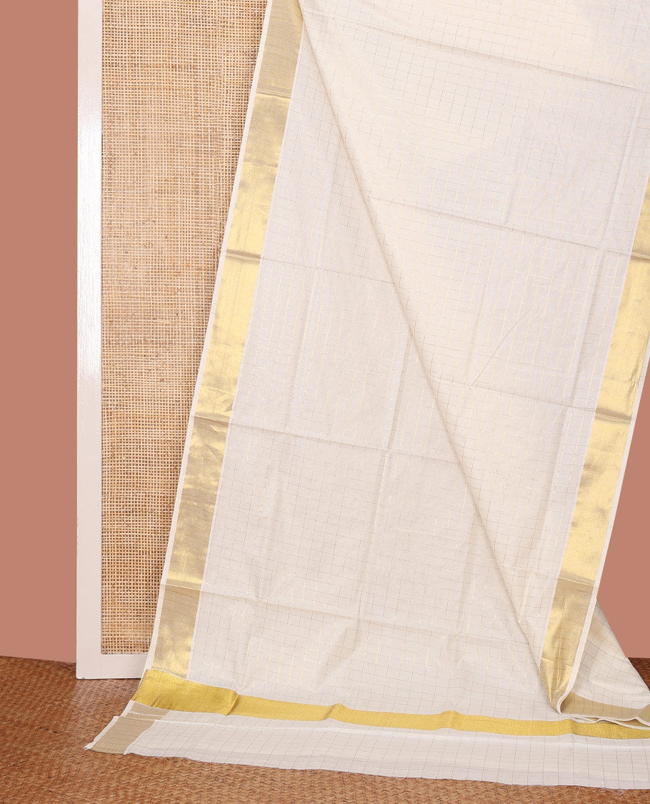 Cream Kerala Cotton Saree Woven with Zari Checks All Over Its Body, Zari Bavanji Border, Gleaming Zari Checked Pallu, and Paired with a Matching Blouse
