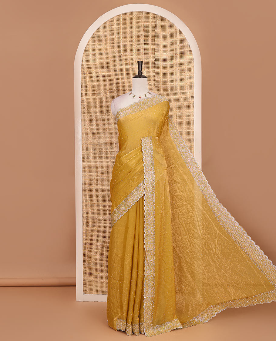 Mustard Swarovski crystal stone embedded fendy chiffon saree, scallop Swarovski stone embroidered border, and contrast plain blouse