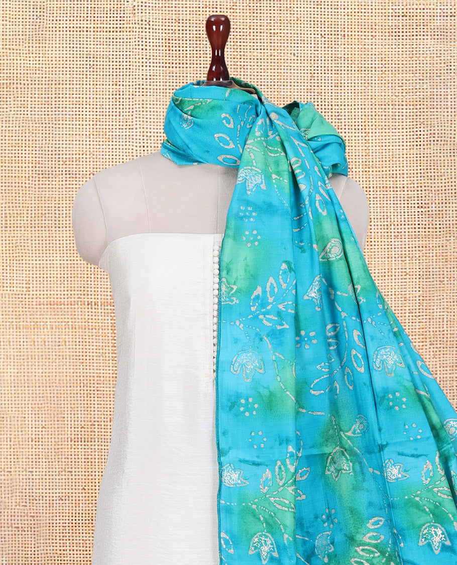 Cream-Rama Blue Kerala Cream Mul Chanderi Material Churidar Features Pom-Pom Neckline Top, a Contrast Batik Floral Printed Bottom, and Dupatta