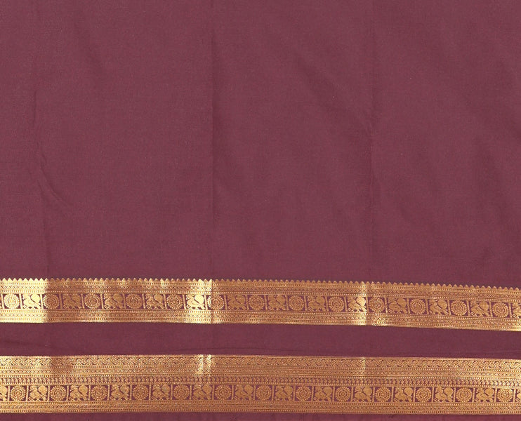 Brown Kanchipuram budget silk saree elevated with zari designs all over its body, complemented by rettai pettu traditional zari design border, Mughal-style intricately woven pallu, and paired with a Matching blouse
