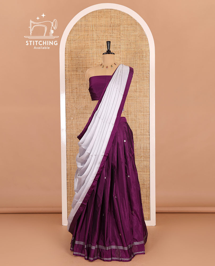 Purple half-saree, buttas with self-bordered taffeta silk skirt, a plain blouse, and a contrast bordered satin georgette dhavani
