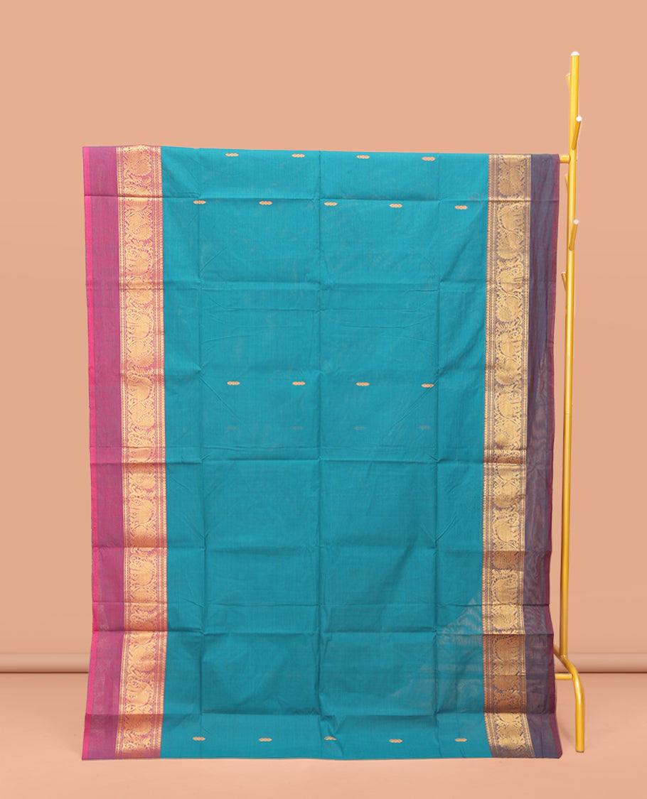 Blue Chettinad Cotton Saree, Adorned with Buttas All Over Its Body, Complemented by a Contrast Ganga-Jamuna Kal Eragina Border of Kodi Peacock and Elephant Designs, Pallu of Buttas and Stripes, and Paired with a Matching Blouse