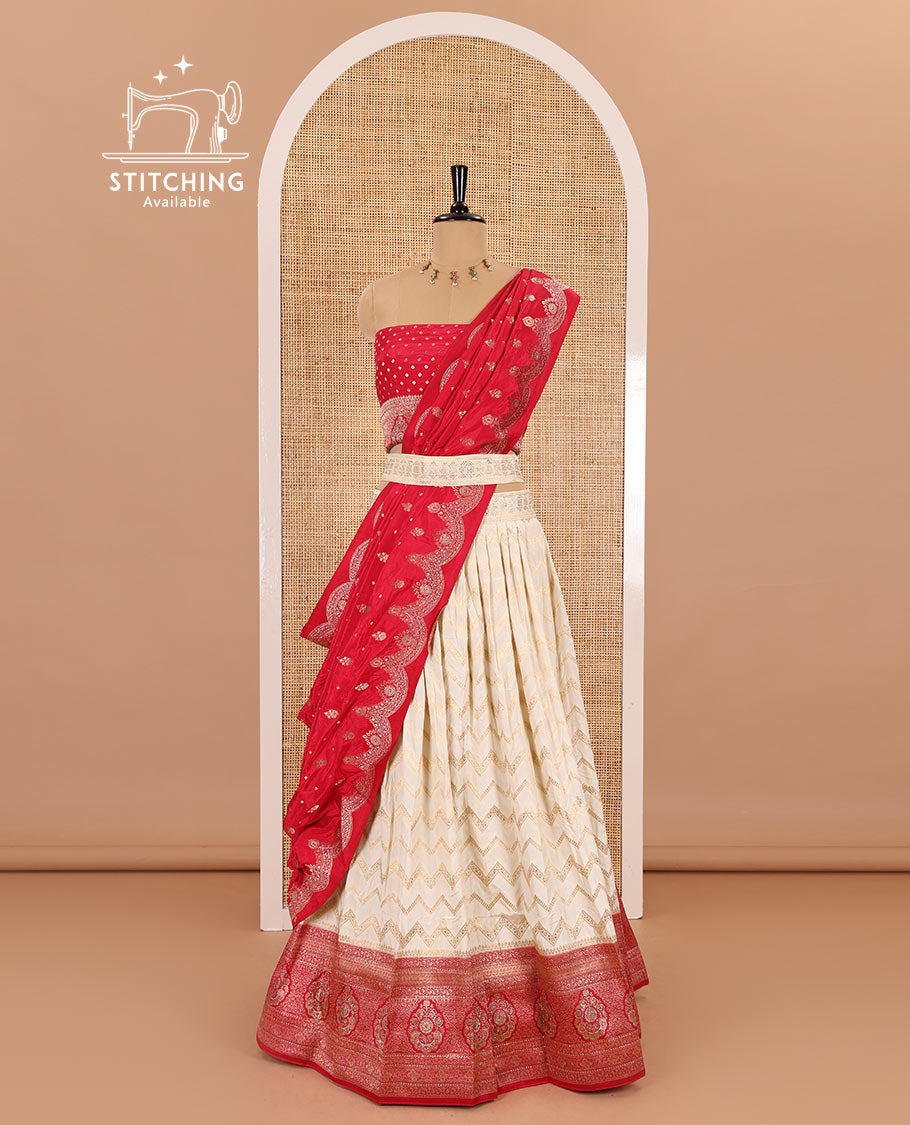 Cream-pink chiniya crepe half-saree, chevron zari jacquard with contrast intricate patterned stone work bordered skirt, contrast blouse, and a scallop bordered intricate dhavani