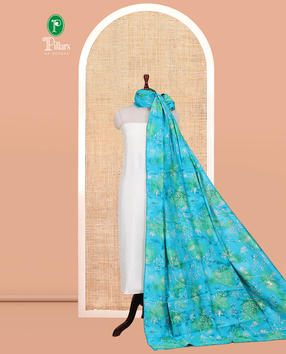 Cream-Rama Blue Kerala Cream Mul Chanderi Material Churidar Features Pom-Pom Neckline Top, a Contrast Batik Floral Printed Bottom, and Dupatta