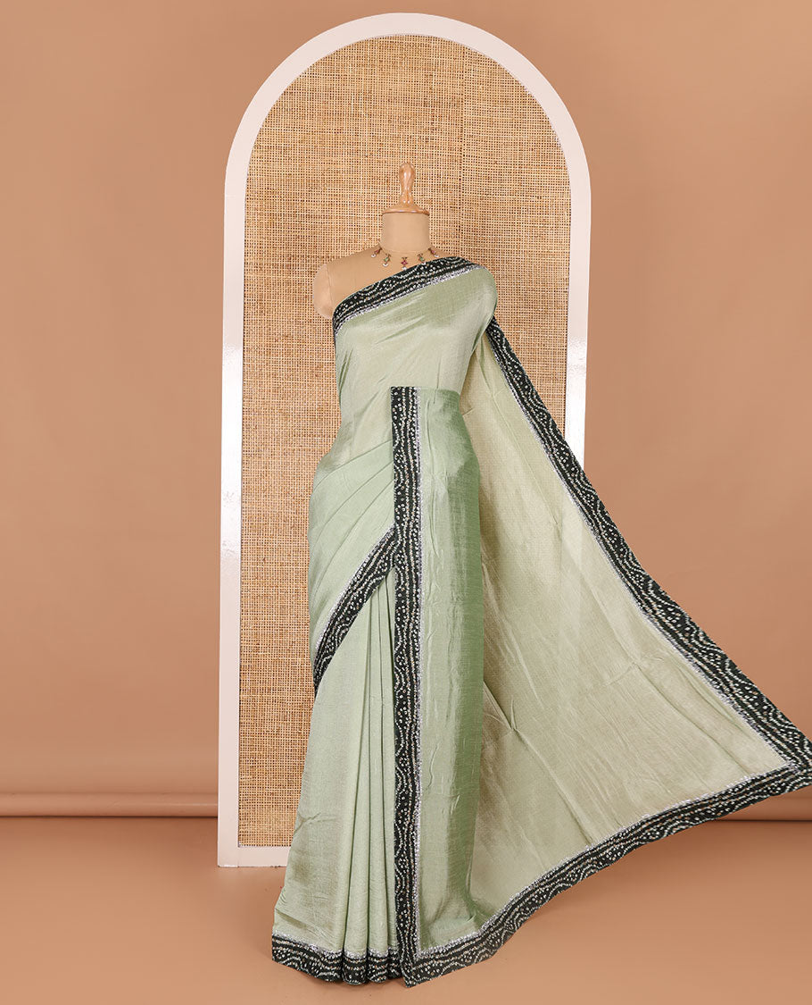 Pista green plain Vichitra silk saree, contrast bandhani printed with Swarovski micro-stonework border, and a contrast bandhani printed blouse