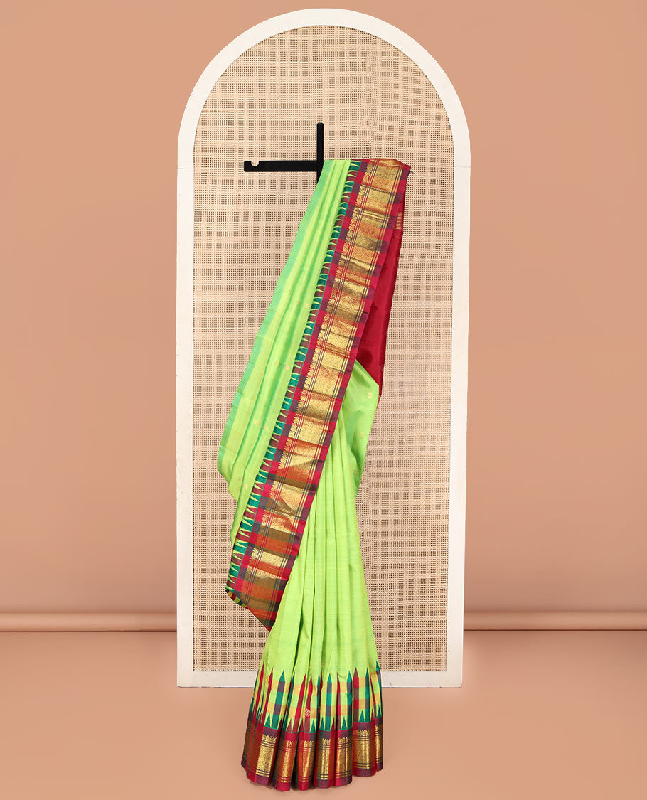 Green Kanchipuram Silk Saree, Delicately Woven with Zari Buttas on Its Body, Complemented by a Contrast One-Sided Thazampoo Rekku Border of Mayil and Jaal Designs, Pallu Depicts Zari Designs, and Comes Without a Blouse