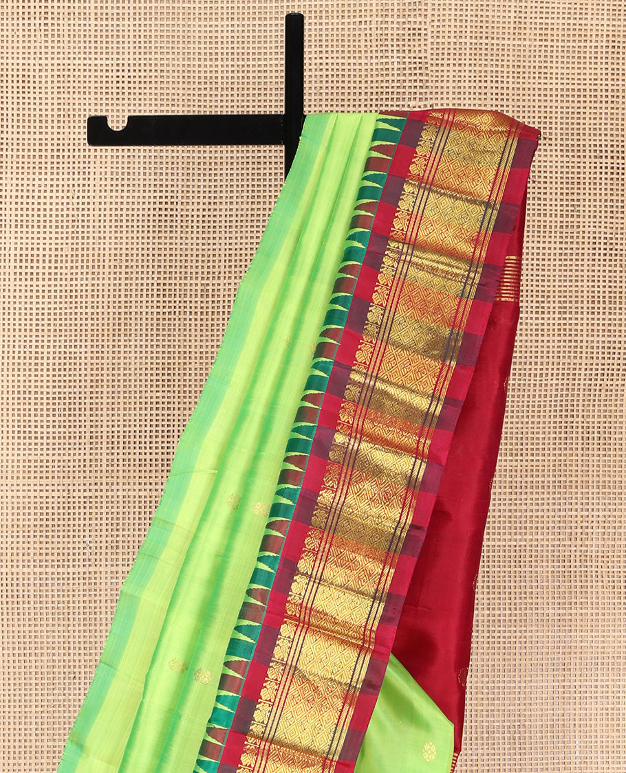 Green Kanchipuram Silk Saree, Delicately Woven with Zari Buttas on Its Body, Complemented by a Contrast One-Sided Thazampoo Rekku Border of Mayil and Jaal Designs, Pallu Depicts Zari Designs, and Comes Without a Blouse