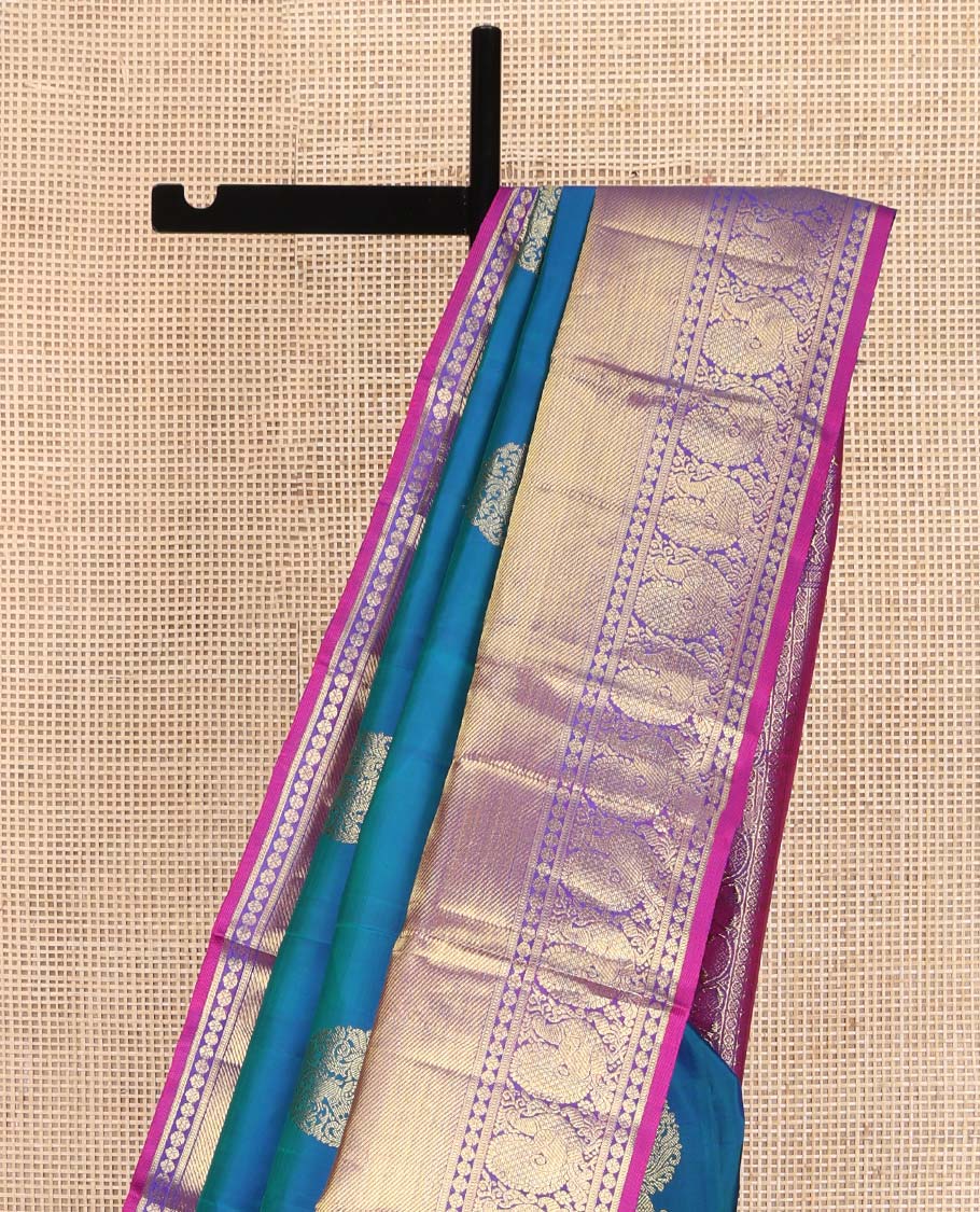 Blue Kanchipuram Silk Saree, Embellished with Zari Buttas All Over Its Body, Complemented by a Contrast Border of Manga Mokku, Poun, Yaali, and Mayil Designs, Pallu of Kodi Visiry Designs, and Paired with a Contrast Blouse