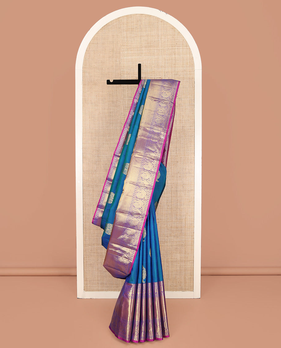 Blue Kanchipuram Silk Saree, Embellished with Zari Buttas All Over Its Body, Complemented by a Contrast Border of Manga Mokku, Poun, Yaali, and Mayil Designs, Pallu of Kodi Visiry Designs, and Paired with a Contrast Blouse