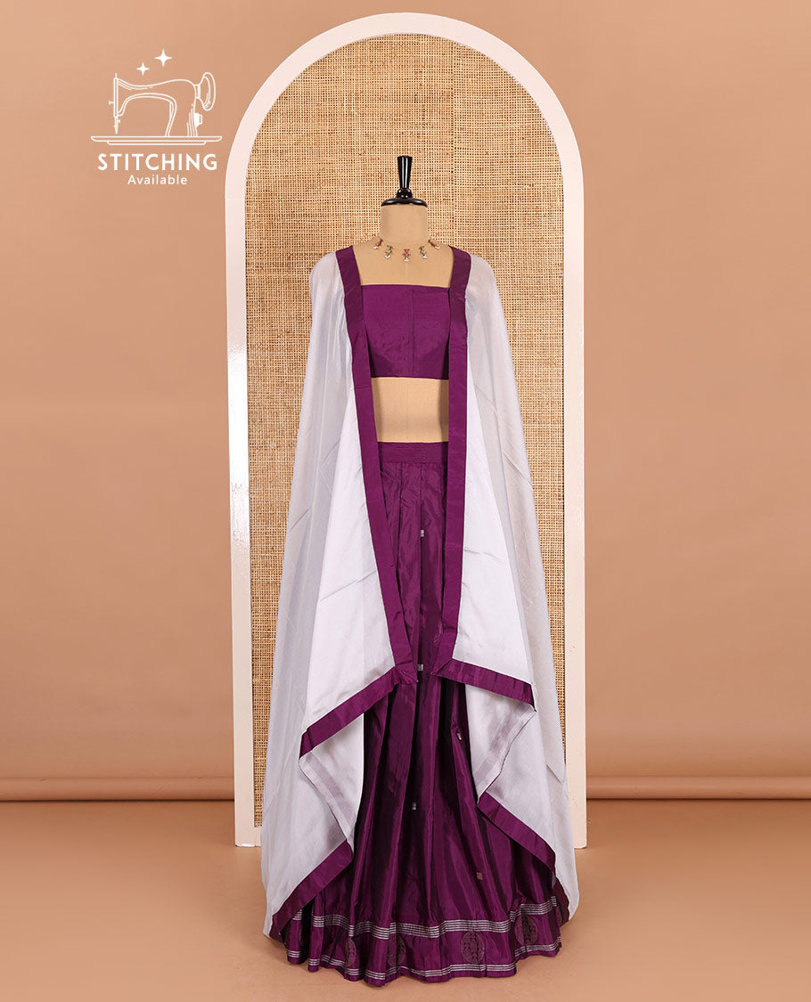 Purple half-saree, buttas with self-bordered taffeta silk skirt, a plain blouse, and a contrast bordered satin georgette dhavani
