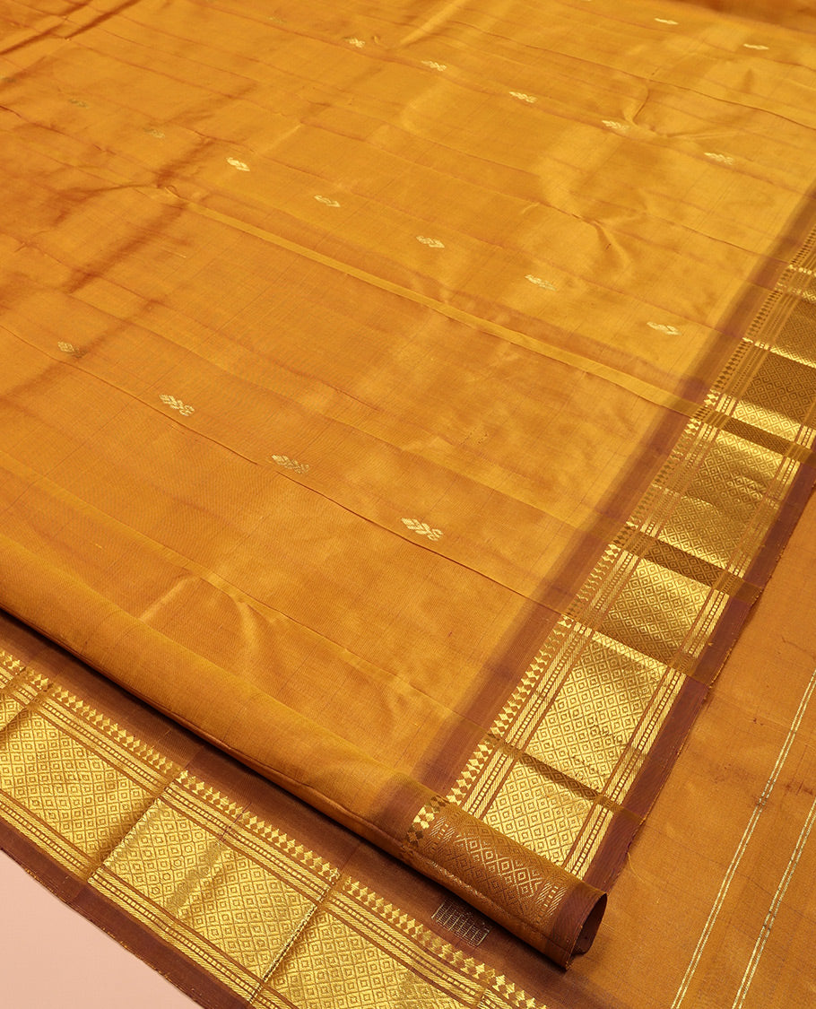 Mustard Kanchipuram Silk Saree, Adorned with Zari Buttas, a Contrast One-Sided Border of Panner Sombu, Banaras, Muthu, and Mayil Kann Designs, Zari Design Pallu, and No Blouse