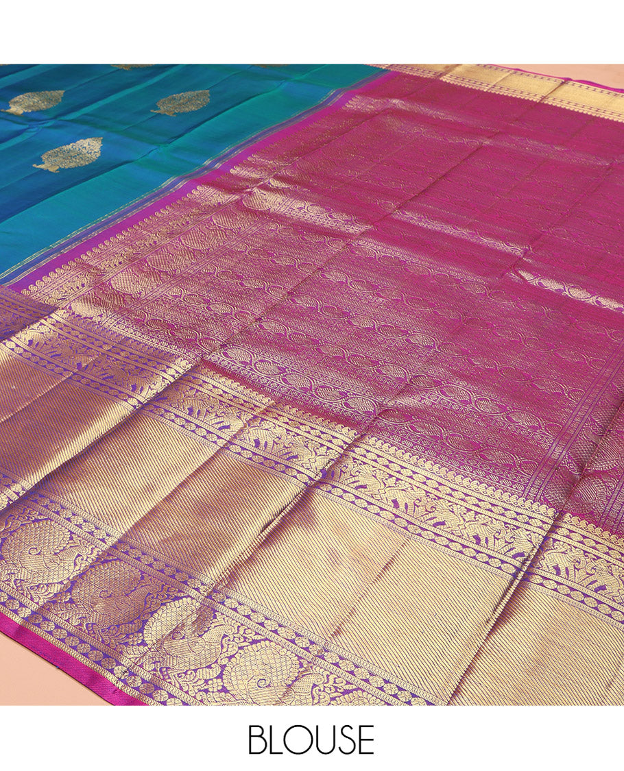 Blue Kanchipuram Silk Saree, Embellished with Zari Buttas All Over Its Body, Complemented by a Contrast Border of Manga Mokku, Poun, Yaali, and Mayil Designs, Pallu of Kodi Visiry Designs, and Paired with a Contrast Blouse
