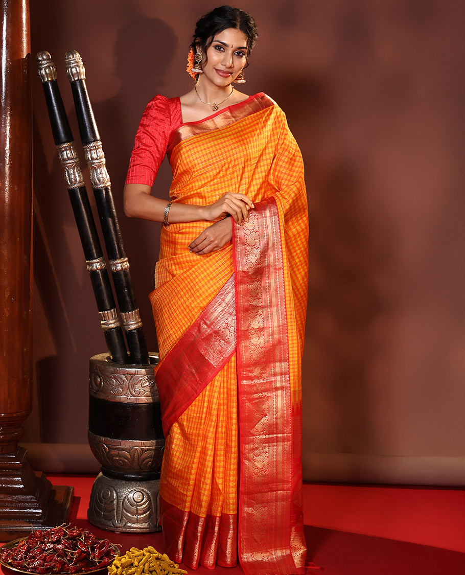 Orange Vasundhara Silk Saree Decked Up with Checks All Over Its Body, Complemented by Contrast Border of Rekku, Neli, Rudraksham, Kathir, and Mayil Designs, a Grand Pallu of Intricate Designs, and Paired with a Contrast Blouse