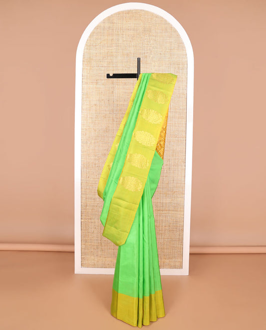 Light green kancheepuram silk sare with contrast floral design border & argyle design pallu