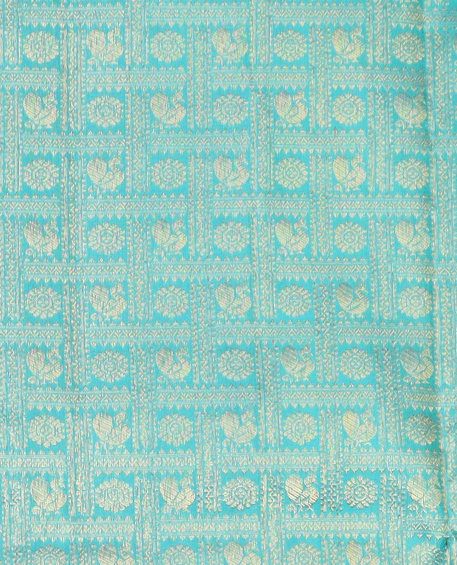 Blue pure silk half saree, mayil chakram enclosed checked skirt, contrast border and blouse of kodi visiry, neli, muthu, lavangam, and jaal, and intricate dhavani