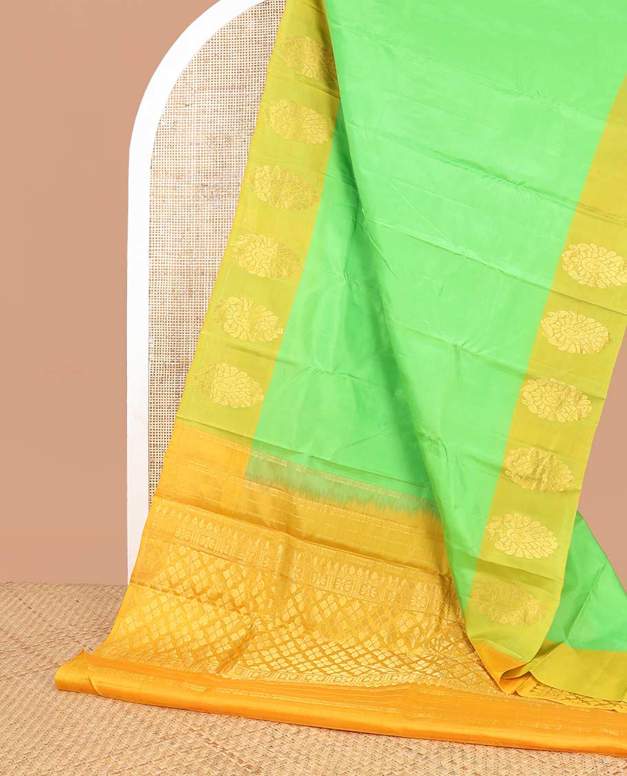 Light green kancheepuram silk sare with contrast floral design border & argyle design pallu