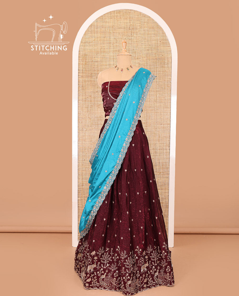 Wine half-saree, buttas and flora-fauna embroidered bordered velvet organza skirt, a matching velvet organza blouse, and a contrast embroidered scallop syska georgette dhavanif