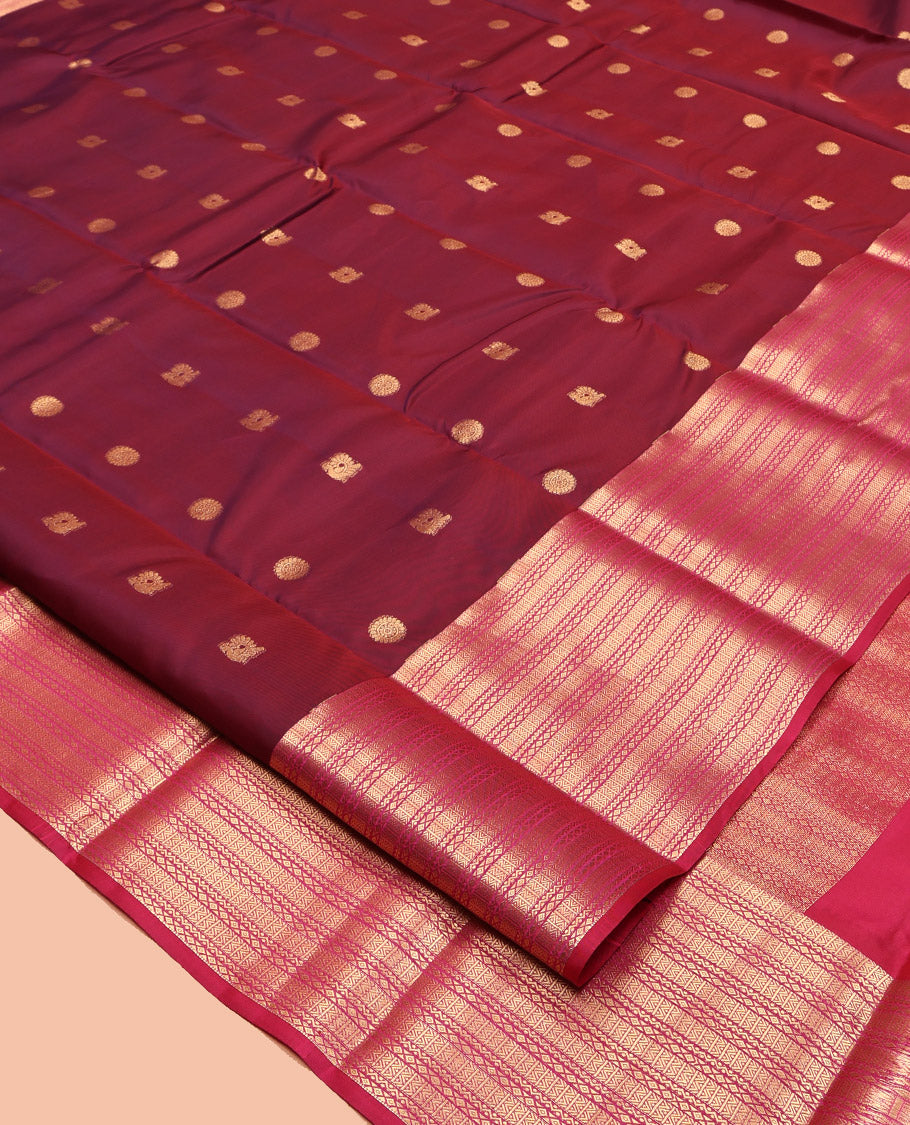 Maroon Vasundhara Lite Silk Mix Saree Features Mayil-Chakram Buttas, Complemented by a Contrast Border of Neli and Diamond, a Geometric Pallu, and a Contrast Blouse