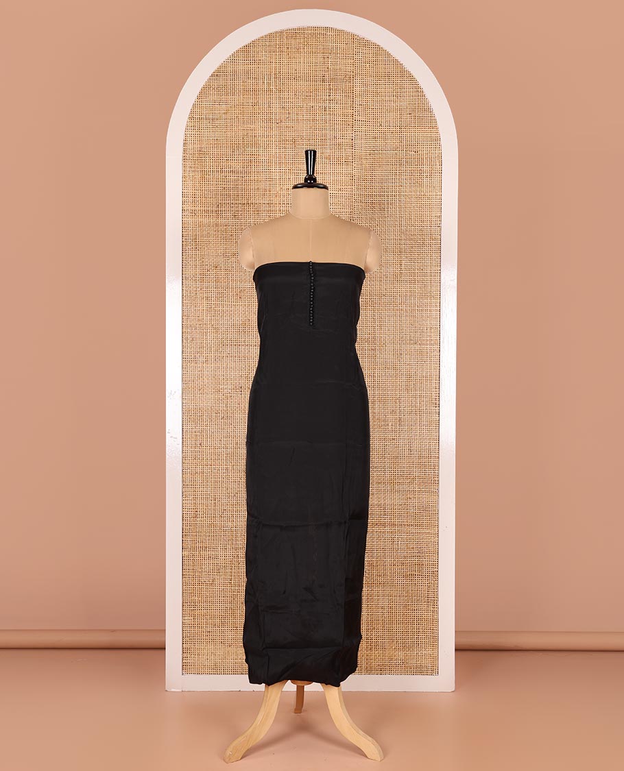 Black material chudidar set, plain with pom-pom tasseled mul chanderi top, a matching bottom, and organza dupatta of stripes