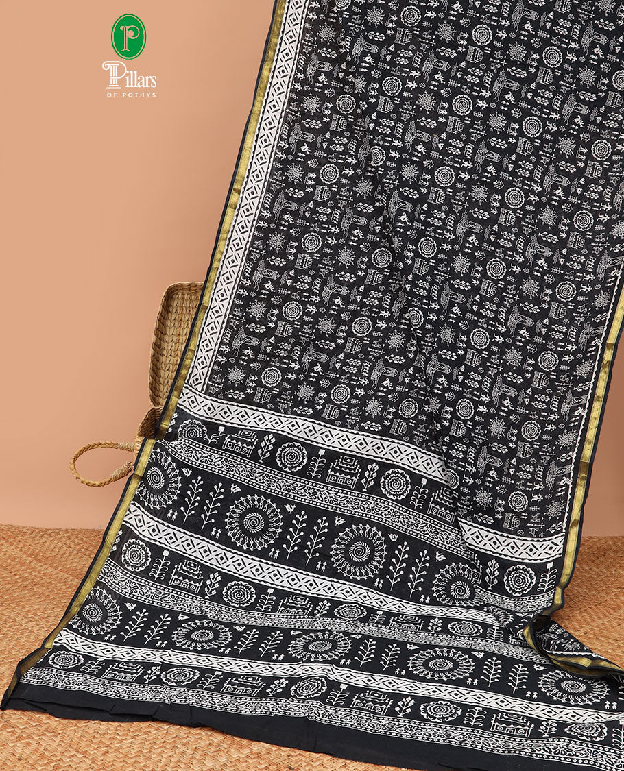 Black worli printed mul mul soft cotton saree with gold zari piping border & worli printed pallu along with bandhini printed blouse