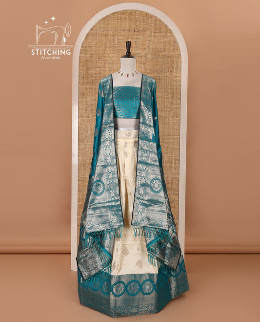 Cream-rama blue semi-banaras half-saree, zari buttas & contrast traditional zari border skirt, jacquard blouse & intricately zari woven dhavani