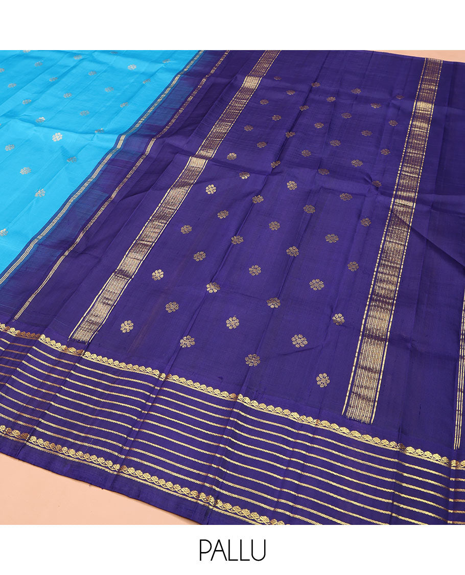 Blue Kanchipuram Silk Saree, Embellished with Zari Buttas, Complemented by Contrast One-Sided Korvai Border of Thilakam Mokku and Banaras Designs, Pallu Steeped with Floral Designs, and Comes Without a Blouse