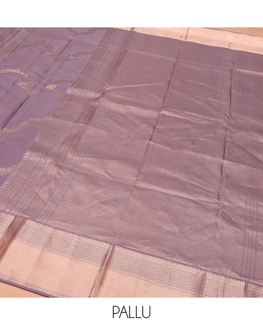 Lavender Vasundhara Silk Saree, Embellished with Floral Jaal Jacquard on Its Body, Highlighted by a Zari Border of Thilakam Mokku, Lavangam, and Jaal Designs, Grandly Woven Jaal Pallu, and Paired with a Matching Blouse