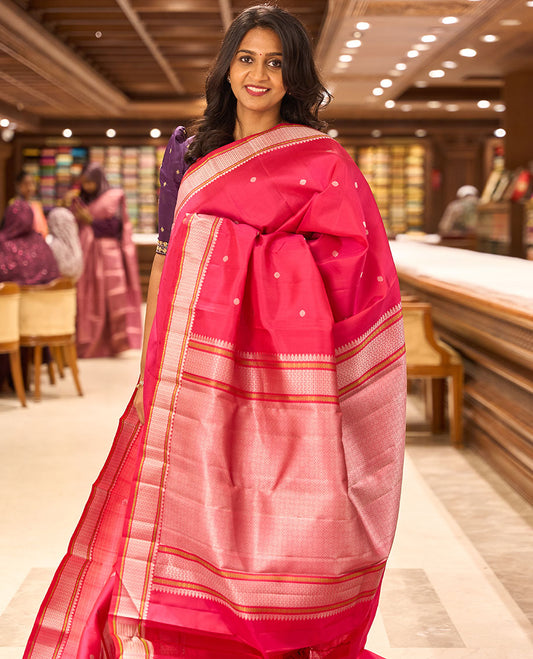 Dark pink floral buttas kancheepuram silk saree with self thread border of thilakam mokku, paun design & jaal pallu