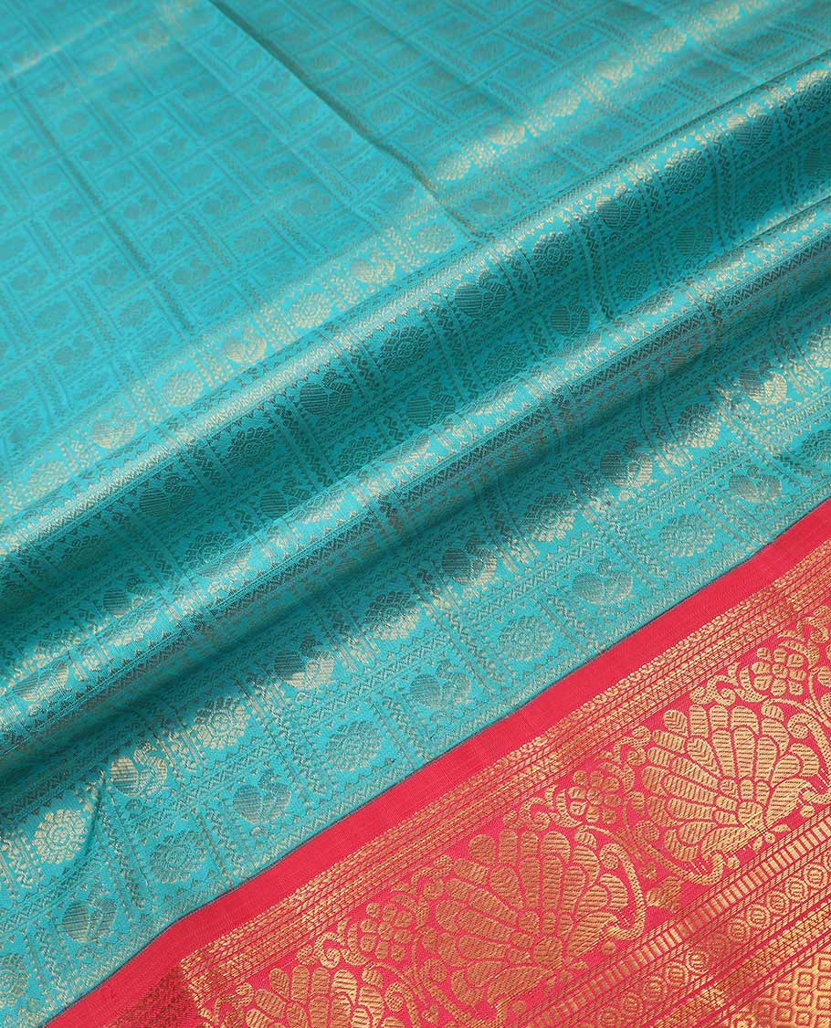 Blue pure silk half saree, mayil chakram enclosed checked skirt, contrast border and blouse of kodi visiry, neli, muthu, lavangam, and jaal, and intricate dhavani