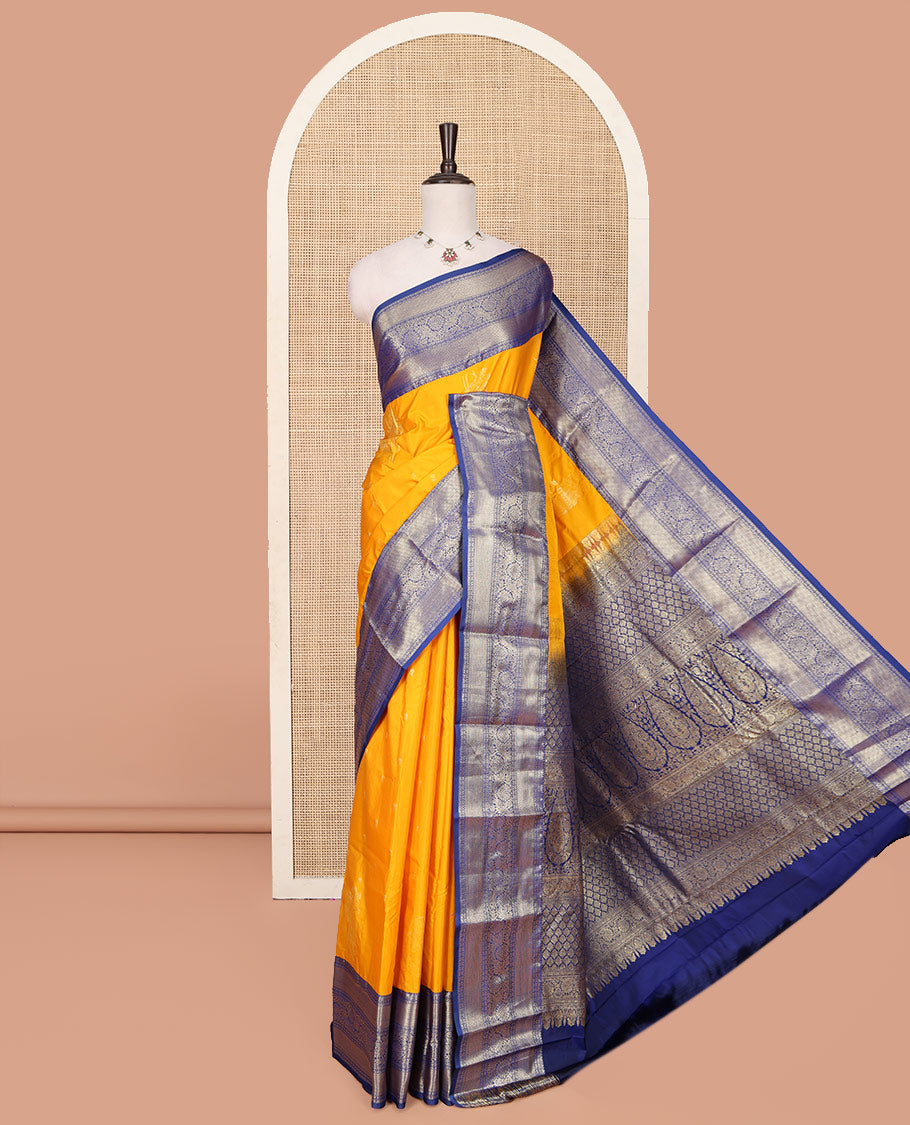 Orange Budget Silk Saree, Delicately Woven with Floral Zari Buttas All Over Its Body, Complemented by a Contrast Traditional Zari Border of Floral Creeper Designs, Grand Pallu of Jaal and Thilakam Designs, and Paired with a Contrast Blouse