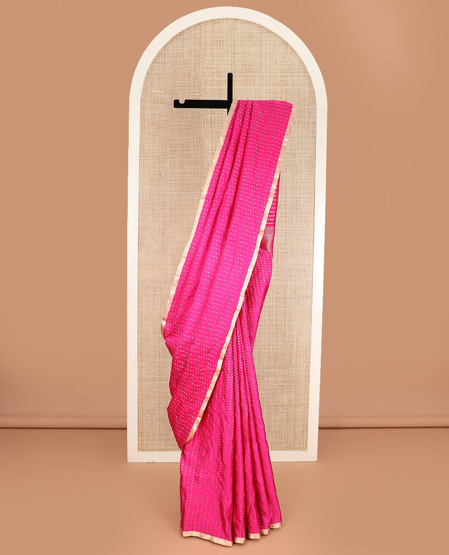 Bright pink dobbly style dotted banarasi silk saree, piping zari border, and chevron striped pallu