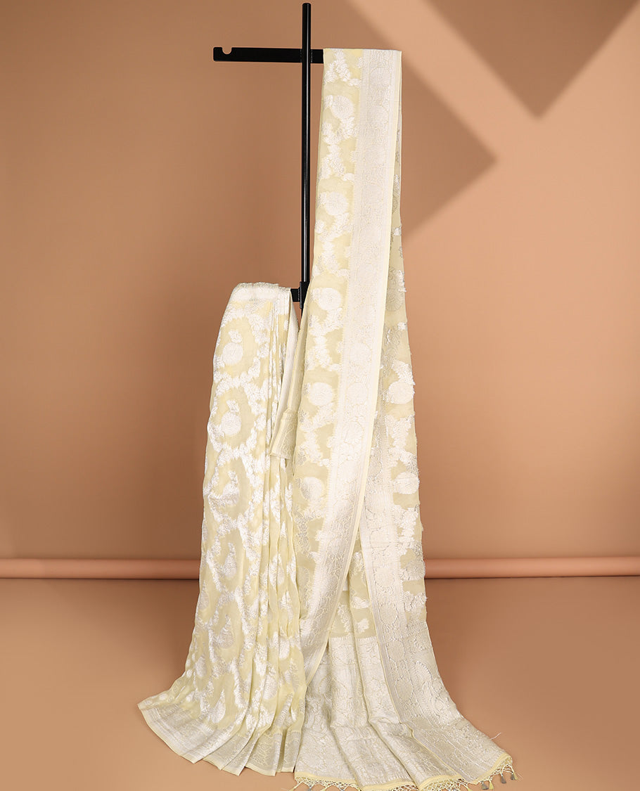 Pale yellow floral jacquard semi-banaras crepe saree, floral creeper border & intricate pallu