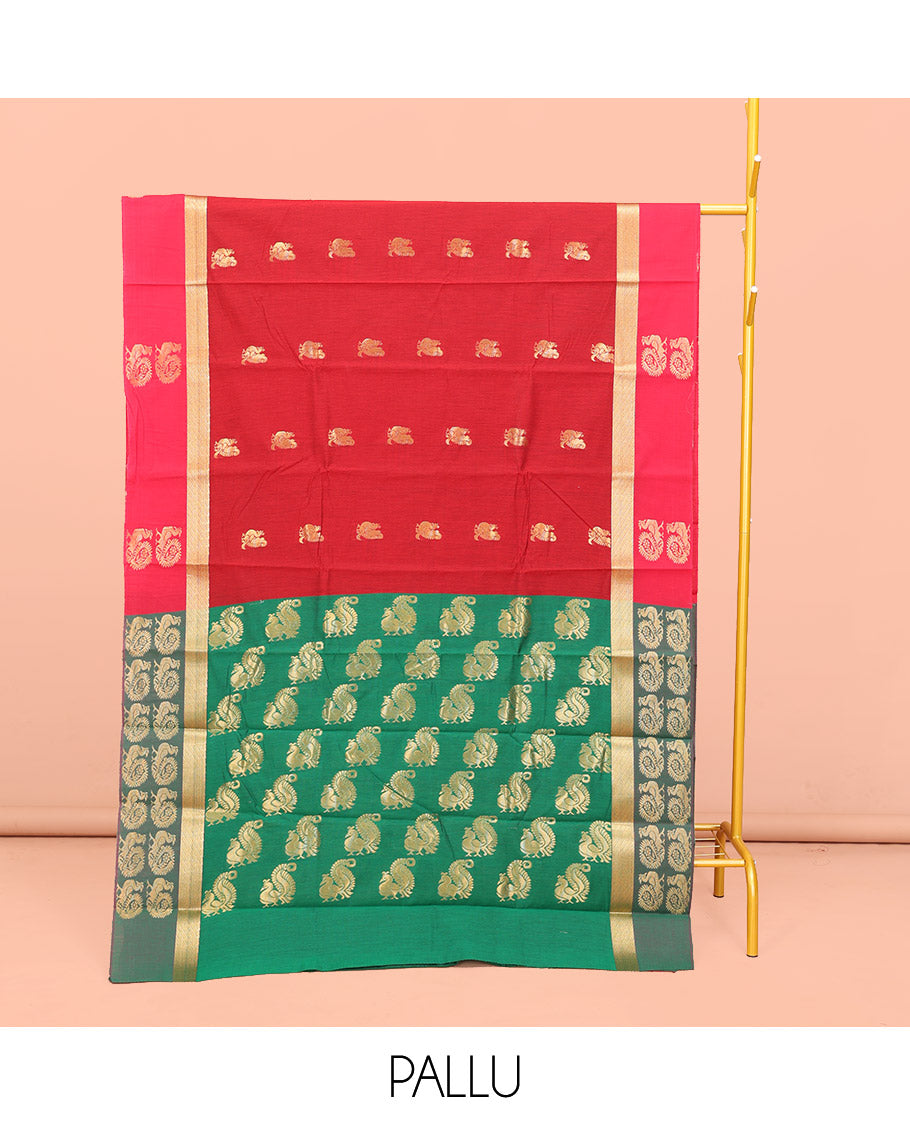 Red Semi-Silk Cotton Saree, Graced with Peacock Buttas All Over Its Body, Complemented by a Contrast Border of Peacock Designs, Pallu Steeped with Peacock Zari Design, and Paired with a Contrast Blouse