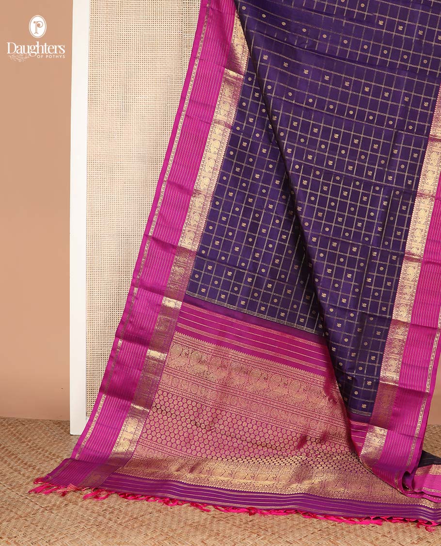 Eggplant purple annam chakram buttas enclosed checked Kanchipuram silksaree, contrast border of thilakm mokku, laddu kamalam, and mayil designs, and intricate pallu