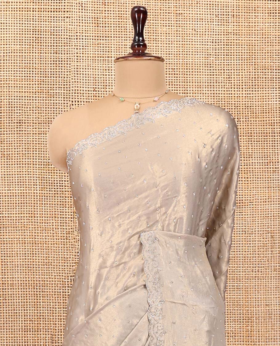 Champagne Designer Saree, Gleamed up with Stone Struck All Over Its Body, Scallop Stone Embroidered Border, and Heavy Embroidered Matching Blouse