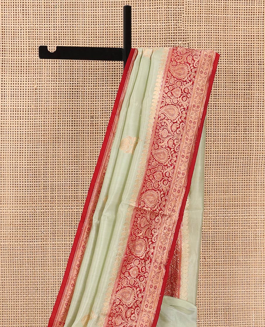 Light Sandal Raw Mango Silk Saree Beautified with Buttas, Featuring a Contrast Paisley Zari-Designed Border, a Zari-Elevated Jaal Pallu, Paired with a Contrast Blouse
