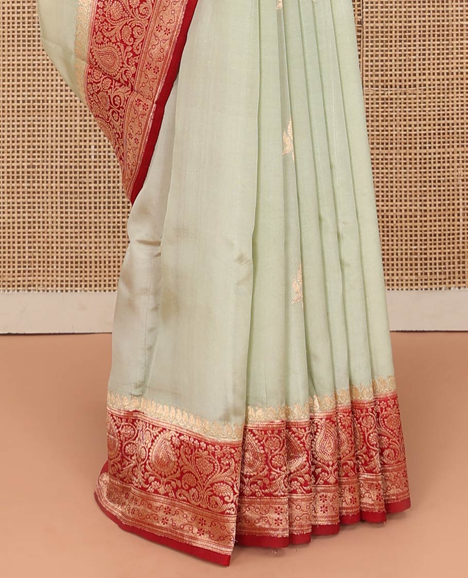 Light Sandal Raw Mango Silk Saree Beautified with Buttas, Featuring a Contrast Paisley Zari-Designed Border, a Zari-Elevated Jaal Pallu, Paired with a Contrast Blouse